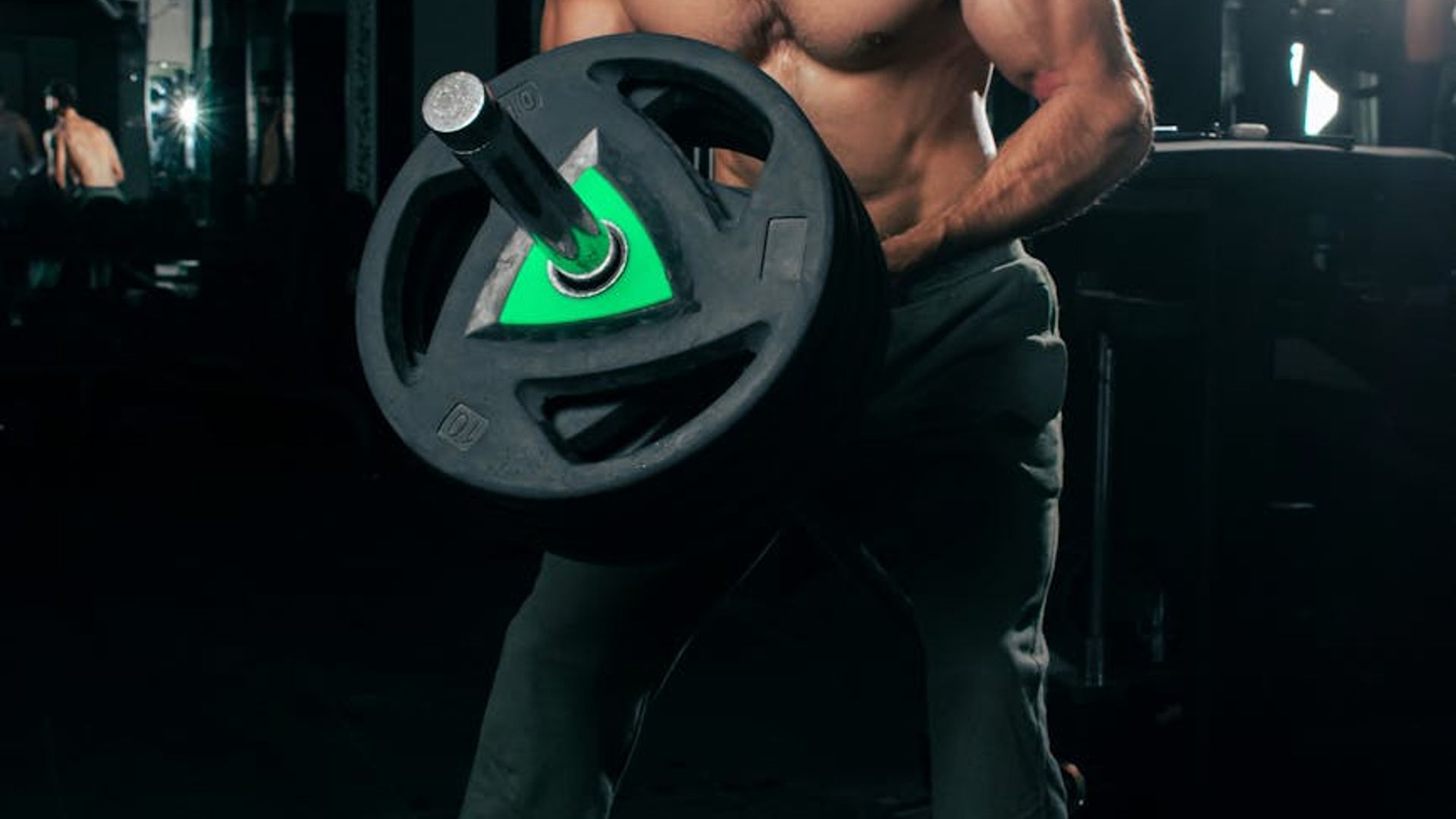 Professional male athlete focused on strength training exercises.